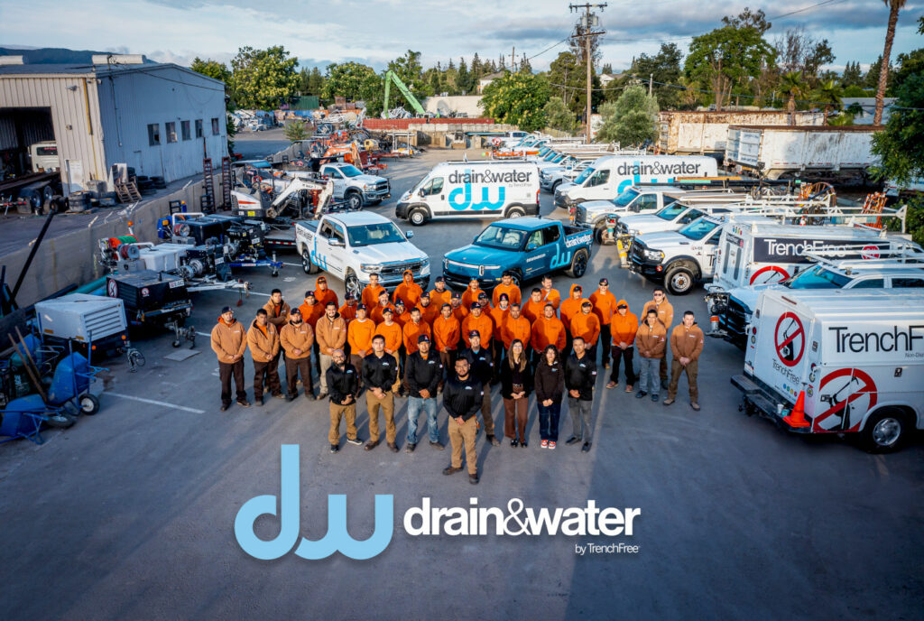 The whole Drain&Water Plumbing team and vehicles outside